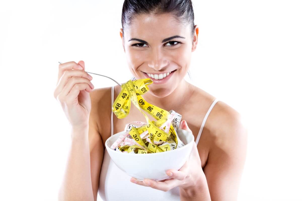 Pretty young woman doing slimming diet. Conceptual image about diet